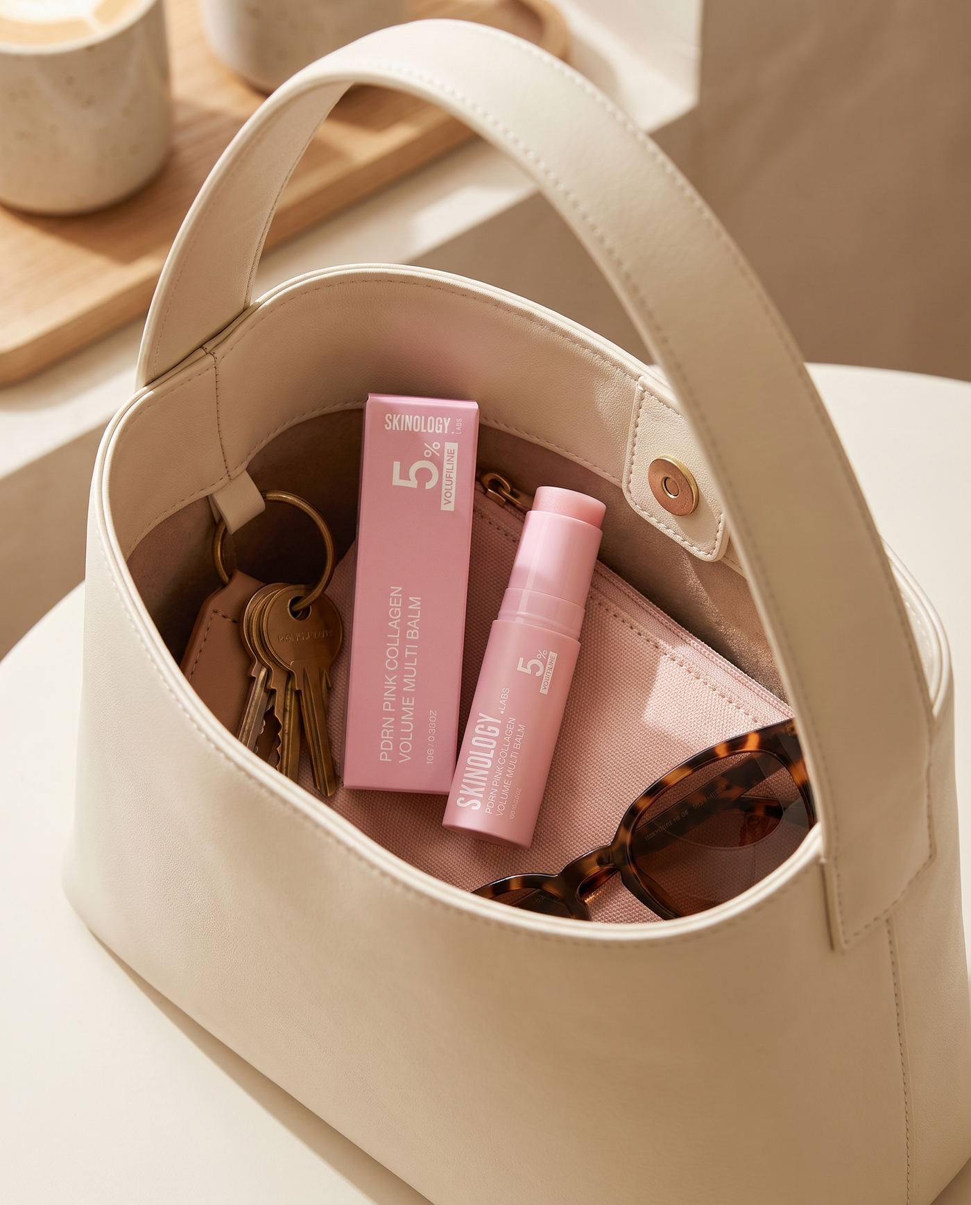 Skinology.Labs PDRN Pink Collagen Volume Multi Balm resting in an open handbag